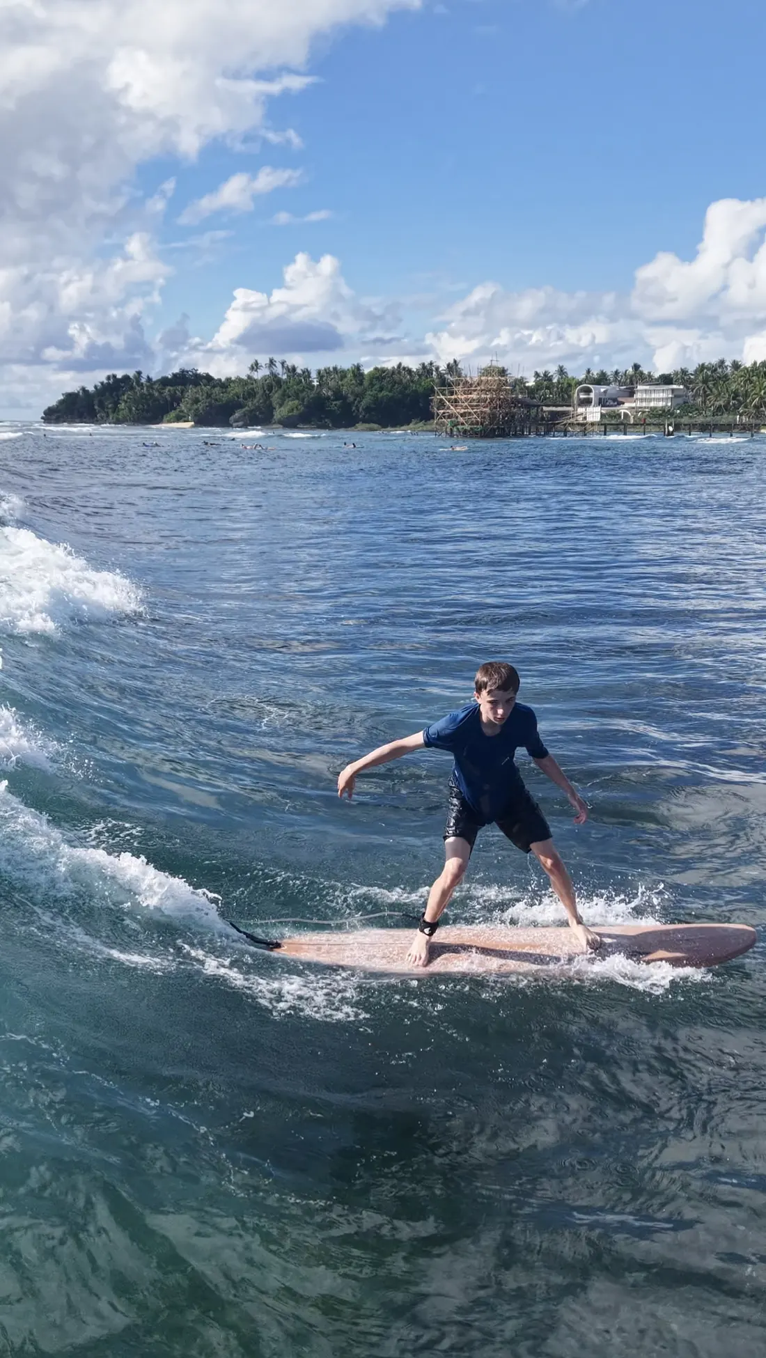 Grom riding toward the palm coast